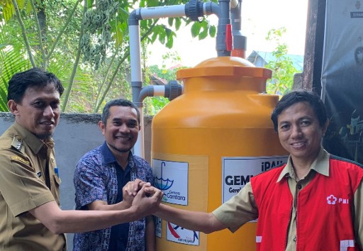 Figure 1. Ternate city coalition members with a rain harvesting unit installed through the project.